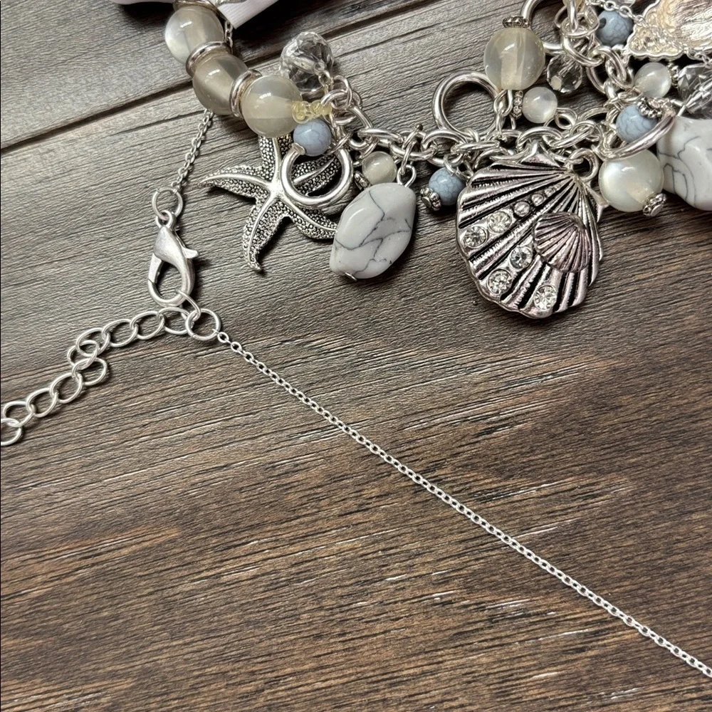 Laura Ford Seashells,Mermaid,Starfish, Silvertone earring & stretch bracelet set